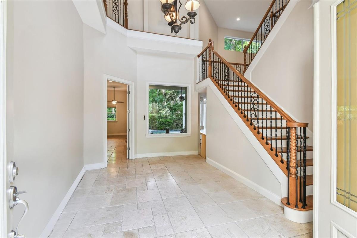 Soaring ceilings as you enter the foyer with views to the backyard.