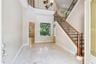 Soaring ceilings as you enter the foyer with views to the backyard.