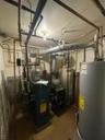 Utility room featuring water heater and a heating unit