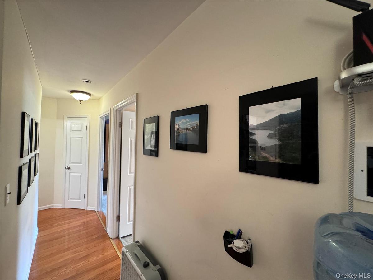 Hall with light wood-style flooring