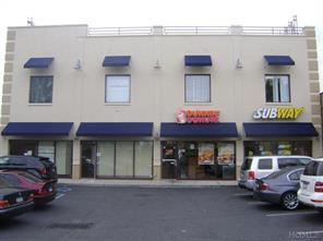 View of building exterior with uncovered parking
