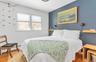 Bedroom with hardwood / wood-style flooring and a baseboard radiator