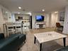 Living area with wood finish floors and recessed lighting