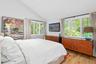 Bedroom with lofted ceiling and light wood-style flooring