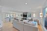Living area with plenty of natural light, wainscoting, light wood-style flooring, crown molding, and recessed lighting