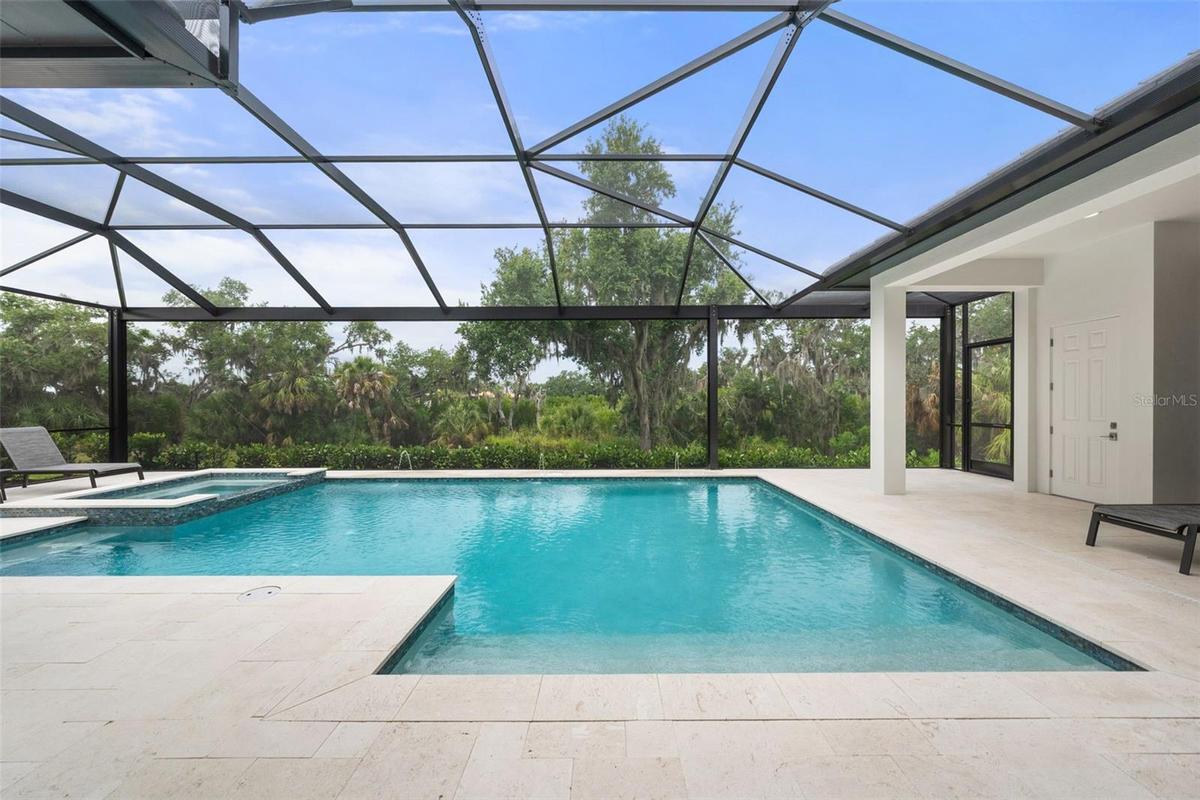 One of the most extraordinary features of the property is the spectacular screened outdoor living space designed to fully embrace Florida’s year-round