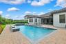 The backyard is the focal point of this property.  Oversized patio with a heated salt pool and built-in spa.