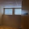 Empty room featuring baseboards, wood finished floors, and a drop ceiling