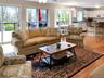 Living room with light wood-style floors, a ceiling fan, and a chandelier