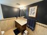 Bathroom with wainscoting, tile walls, vanity, and light tile patterned floors