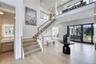 Stairs with french doors, wood finished floors, and a high ceiling