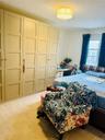 Bedroom with carpet floors and a chandelier