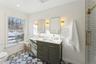 Bathroom with toilet, a sink, and sunlight