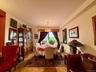 Open to the living room, double panel window, hardwood floors