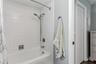 En-suite bathroom with shower/tub combo.