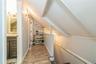 Upstairs Hallway featuring wooden walls, lofted ceiling, hardwood / wood-style flooring