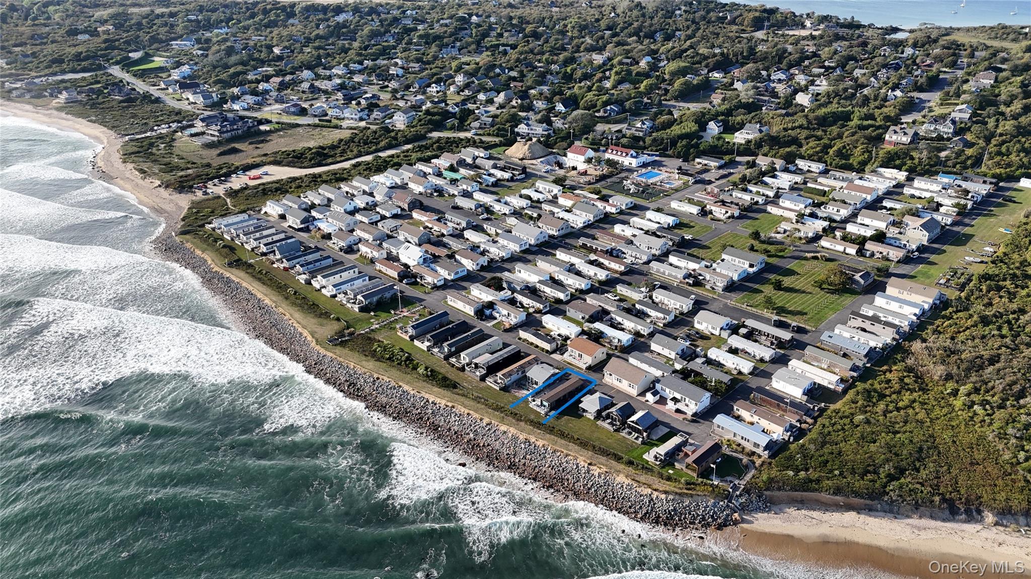 View of property location with expansive beach and nearby suburban area