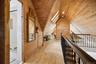 Finished Attic / Loft- Beautifully finished attic featuring warm wood-paneled walls and vaulted ceilings, skylights, and an open loft-style layout. Th