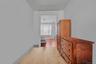 Corridor featuring light wood finished floors and baseboards