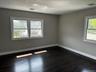 Spare room featuring dark wood-style flooring