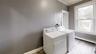 Washroom featuring crown molding, a healthy amount of sunlight, independent washer and dryer, and light hardwood / wood-style floors