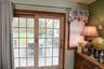 Glass-paned sliding patio doors opening to an outdoor deck area