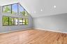 Bedroom featuring baseboards, light wood-type flooring, high vaulted ceiling, and recessed lighting