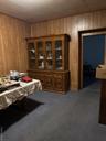 Dining room with wooden walls, dark colored carpet, and pool table