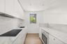 Contemporary kitchen featuring light wood-finish flooring and recessed lighting