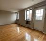 Entryway featuring a baseboard radiator and wood finished floors