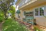 Spacious side yard with custom built potting bench and french doors leading into the Dining Room