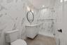 Bathroom with vanity and a marble finish shower
