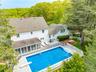 View of swimming pool with a patio, a diving board, a sunroom, and a fenced backyard