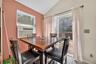 Dining space featuring lofted ceiling, light tile patterned flooring, and cooling unit