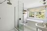 Full bathroom featuring a shower stall, a soaking tub, and tile patterned floors