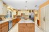 Beautiful glazed custom cabinets with granite counter tops walk in pantry , Stainless steel appliances which includes a Viking Range.