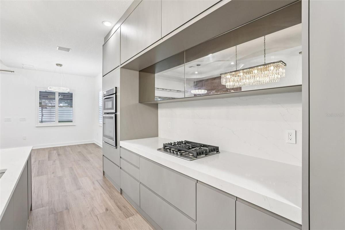 Kitchen is complete with a built-in gas cooktop.
