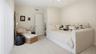 Bedroom with queen daybed, and sliding doors to yard & pool.