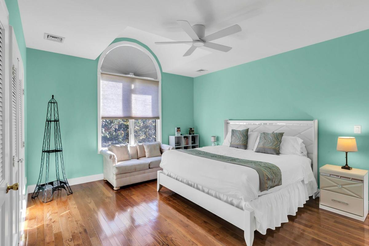 Bedroom with wood-type flooring and a ceiling fan