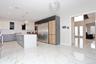 Kitchen featuring hanging light fixtures, modern cabinets, appliances with stainless steel finishes, a kitchen island, and gray cabinetry