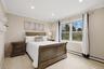 Recessed lighting, crown molding, double-pane window, baseboard heating, and carpet flooring