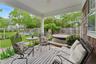 Fenced backyard with a covered hot tub and a wooden deck