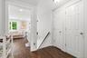 A bright and welcoming second-floor apartment entry featuring a modern, clean aesthetic with immediate appeal.