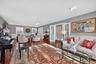 Living area featuring hardwood / wood-style flooring, a wainscoted wall, french doors, and a decorative wall