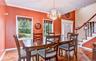 Dining space featuring wood  flooring, a crystal chandelier, and two large windows