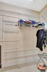 Walk in closet in primary bedroom