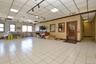Office space featuring a drop ceiling, ornamental molding, light tile patterned flooring, and baseboards