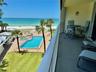 Gulf Front kitchen with grill and outdoor dining options, along with the pool, spa, and plentiful chaise lounges, are surrounded by lush tropical land