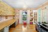 Another view of home office which highlights cabinetry and view out front of house and french doors next to front entry.