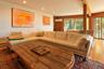 Lower level living area with wooden walls, hardwood / wood-style flooring, beamed ceiling, a wall mounted AC, and recessed lighting